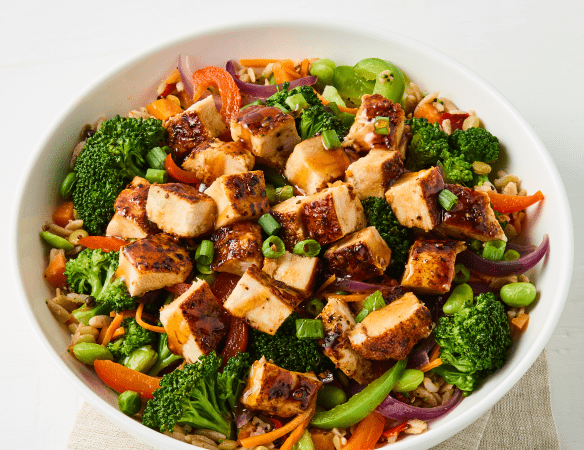 The new Hot Honey Chicken Bowl features grilled chicken, scallions, bell peppers, carrots, edamame and broccoli, drizzled with Mike's Hot Honey and served over an ancient grain and quinoa blend.