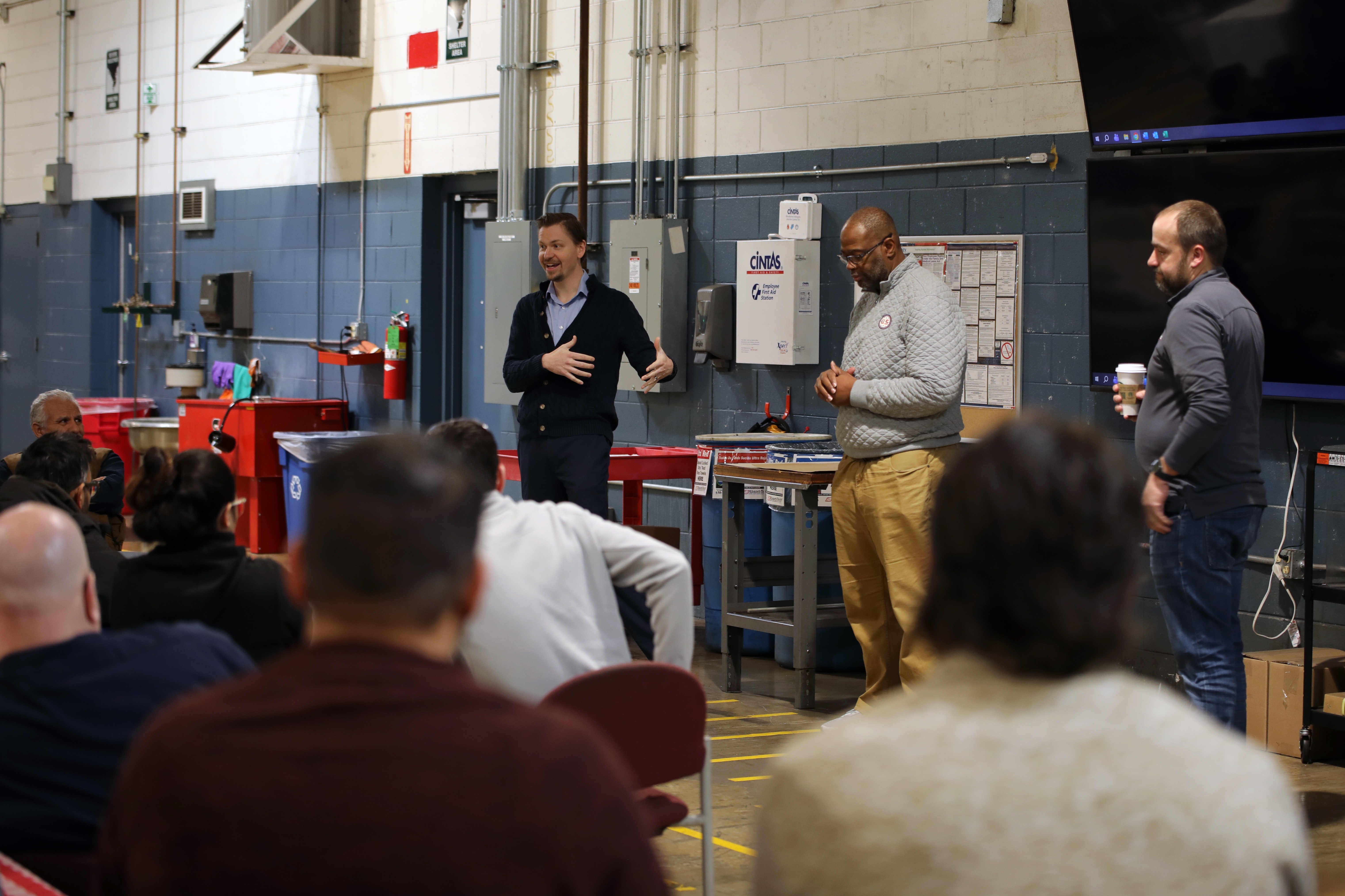 James and Adam announce acquisition to Pack Logix team members during a special town hall-style meeting