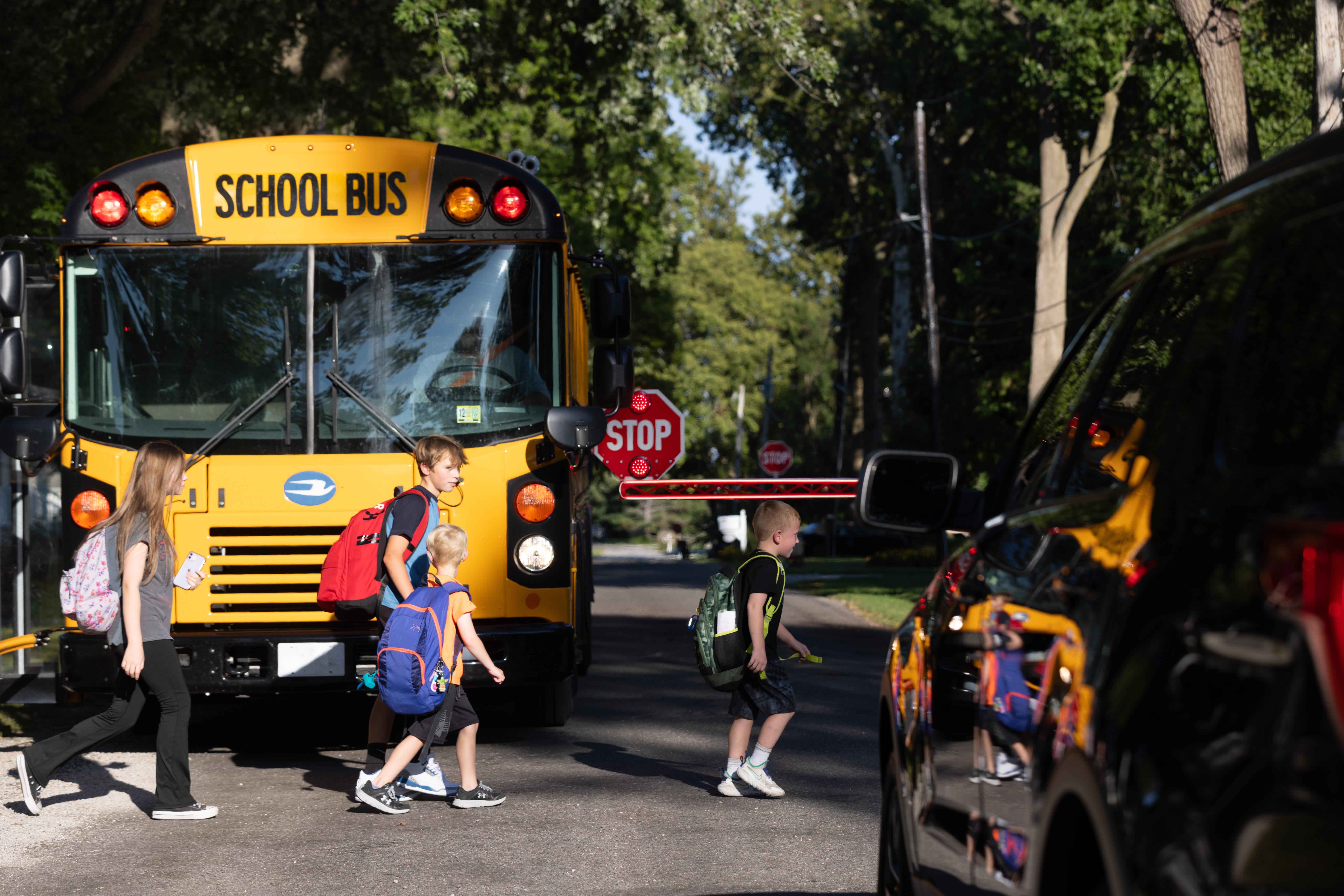 A school bus waits for students to cross the street after school