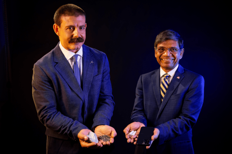 Anthony Caruso, UMKC vice chancellor of strategic initiatives and the founder of Critical Materials Crossroads and UMKC Chancellor Mauli Agrawal hold critical materials — nickel, in this case — and everyday products that rely on them including batteries and mobile phones. Critical Materials Crossroads aims to be in the crucial middle of the supply chain through innovation and creating manufacturing capacity