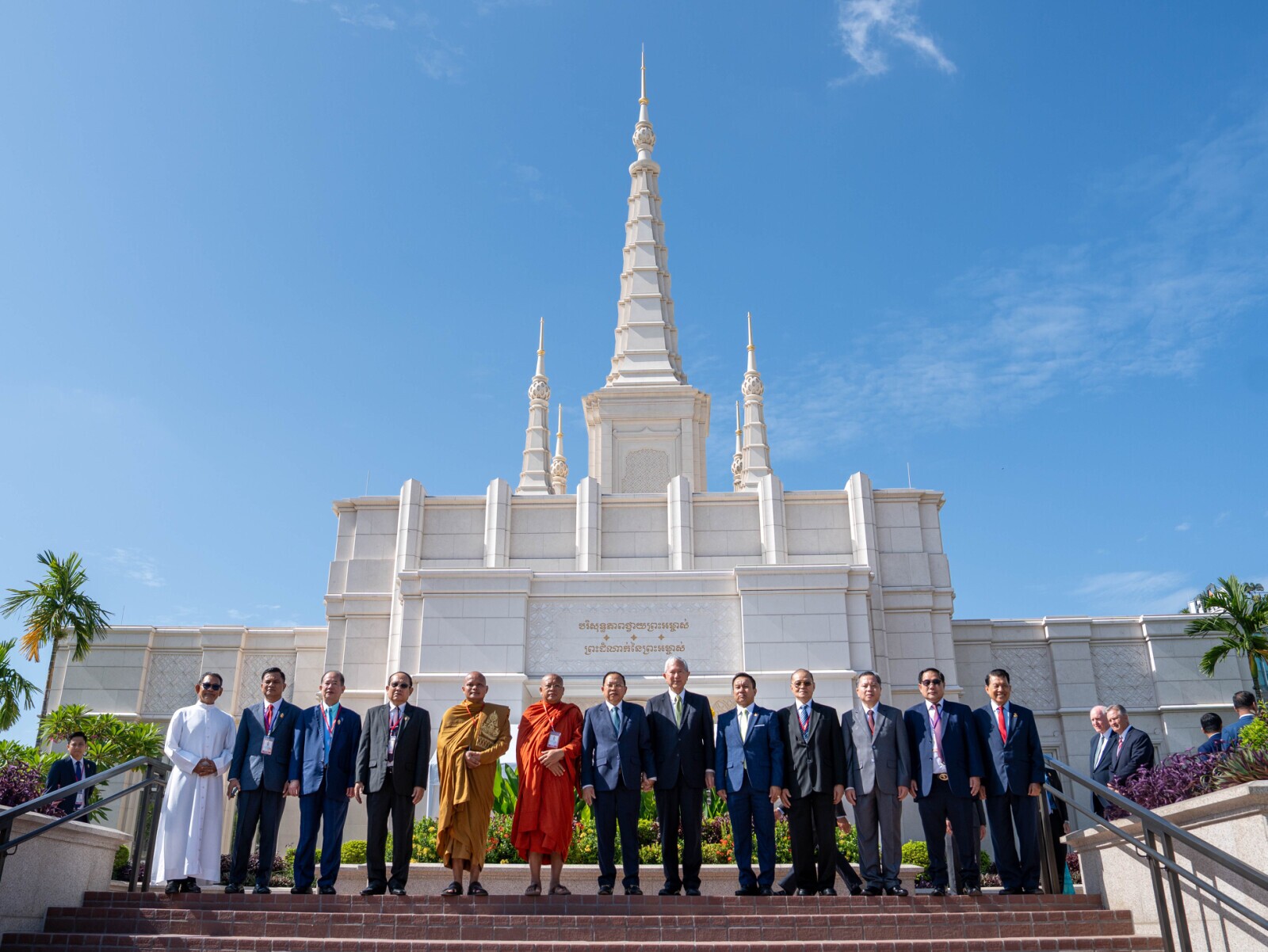 A diverse group of government and interfaith leaders pose for a photo in front of the Phnom Penn Cambodia Temple on Wednesday, Aug. 12, 2026, during the temple's open house celebration, including Elder Gerrit W. Gong of the Quorum of the Twelve Apostles of The Church of Jesus Christ of Latter-day Saints and His Excellency Minister of Cult and Religion Dr. Chay Borin (center).