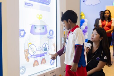 PCF Sparkletots Preschool student interacting with WonderBot 2.0 at the Children’s Museum Singapore