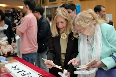 Visitors inspected the exhibition Mutual Learning Among Civilizations with a Shared World Vision, curated by the Xiling Seal Engraver’s Society. (PRNewsfoto/CICC)